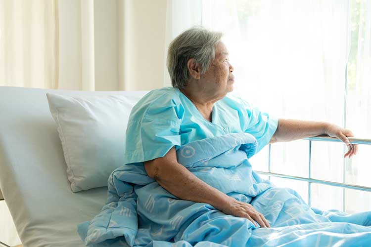 resident in bed with bed rails
